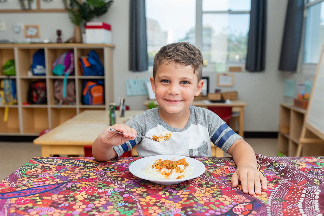 Child eating at First Grammar Wyoming