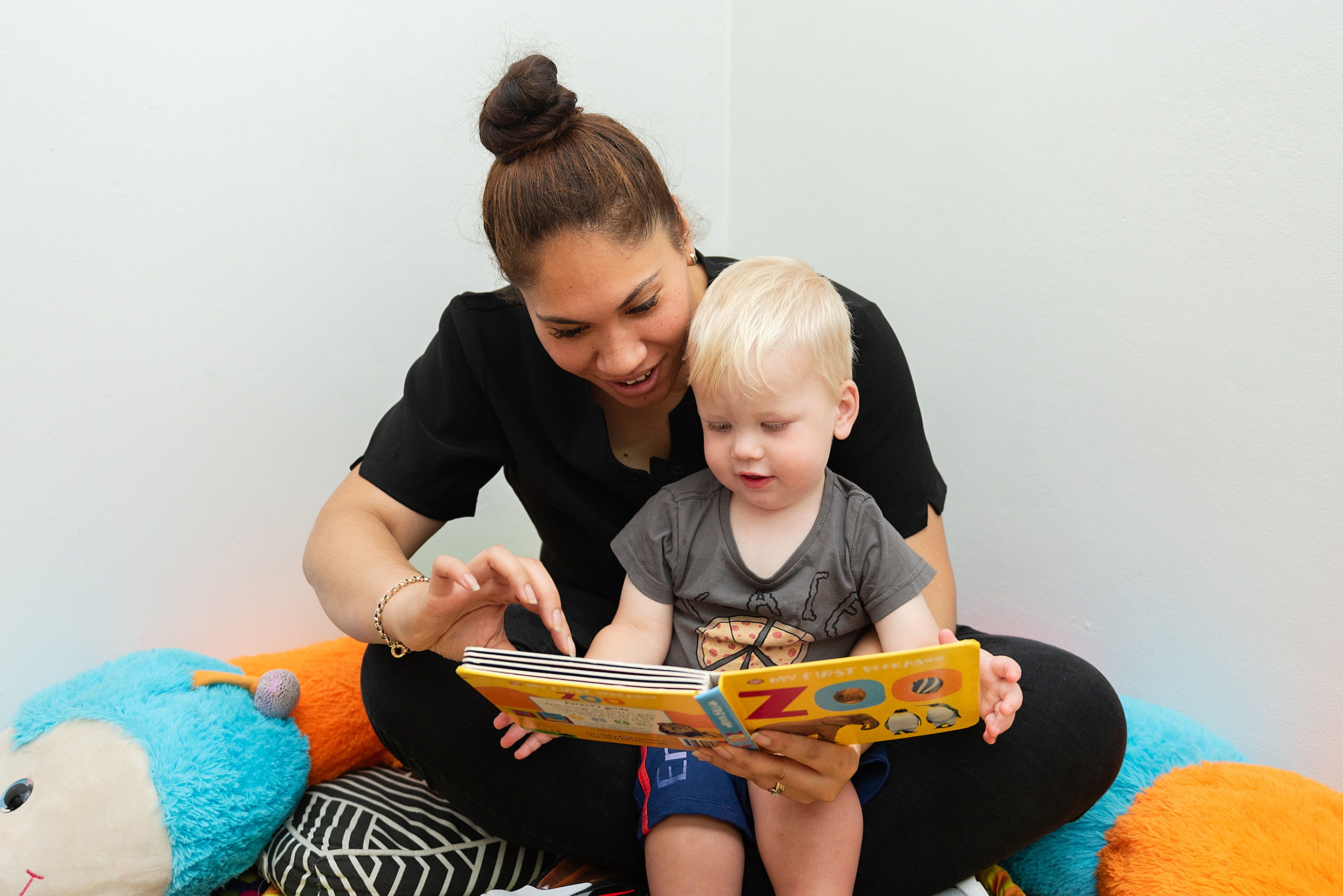 Kindergarten educator reading to a child